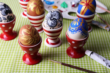 Painting Easter eggs on table close up