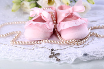 Baby shoe, flowers and cross for Christening
