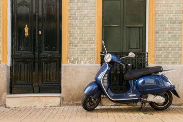 View of a vintage vespa scooter parked on a spanish town.