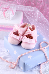 Pink baby boots with gift close-up