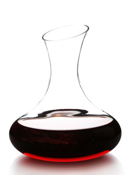 Glass carafe of red wine isolated on white