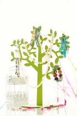 Decorative stand with jewelry and bijouterie on table in room