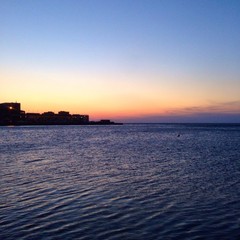 Fototapeta na wymiar Trieste's harbor view at sunset