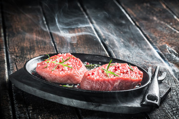 Grilling fresh piece of red meat with herbs