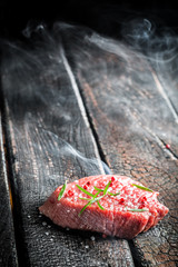 Roasting fresh steak with rosemary