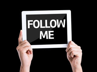 Tablet pc with text Follow Me isolated on black background