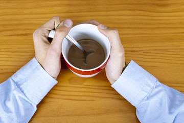 hands on the table with cup of coffee
