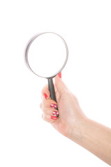 Female hand holding magnifying glass on a white background