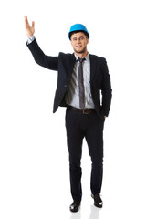 Businessman in hard hat showing copyspace.