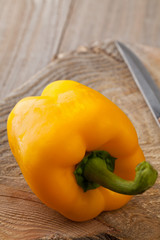 Whole yellow bell pepper on kitchen table