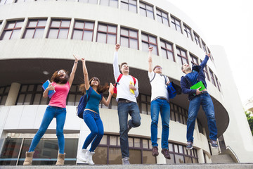 Happy young group of students jumping together