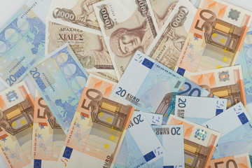 Old Greek 1000 drachmas banknotes and euro bills.