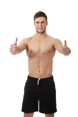 Fototapeta premium Sexy muscular man showing thumbs up.