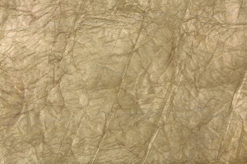 Golden crumpled wrapping paper. Abstract background for design
