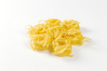 Nests of dry pasta tagliatelle