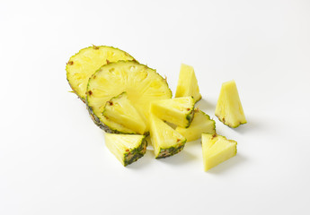 Fresh pineapple slices and wedges