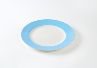 Empty white-blue dinner plate