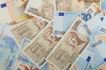Old Greek 1000 drachmas banknotes and euro bills.