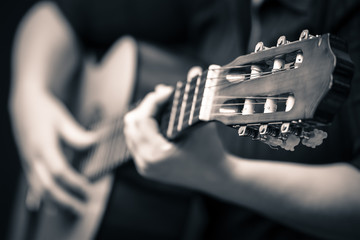 Musician hands playing an acoustic guitar