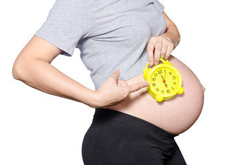 Pregnant woman's belly with clock