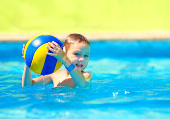 cute kid playing in water sport games in pool © Olesia Bilkei