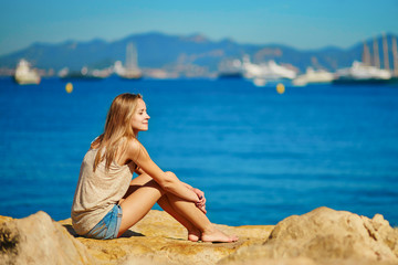 Fototapeta na wymiar Beautiful girl enjoying her vacation by the sea