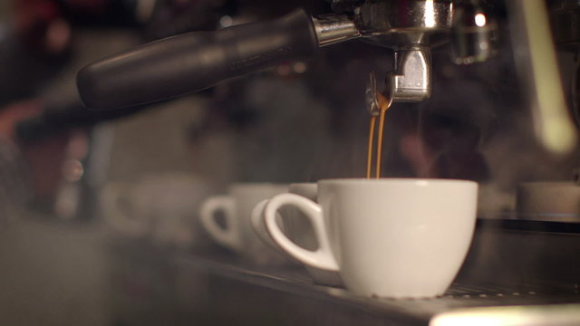 Preparing cups of espresso at a busy coffee shop