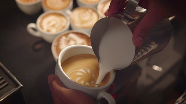 Closeup of Barista making latte art
