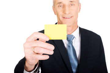 Businessman showing a yellow identity name card