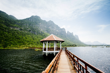 The wooden bridge in lotus lake and wood waterfront pavilion, at