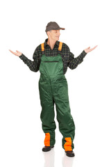 Gardener in uniform showing space with both hands