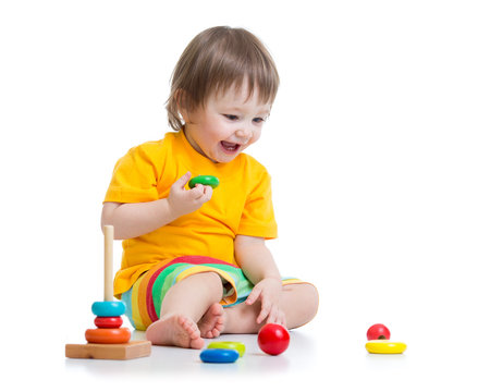 baby playing with pyramid toy