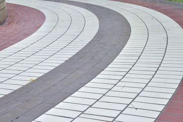 Curve walkway arrange by color brick.
