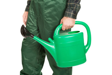 Workman hand holding green watering can