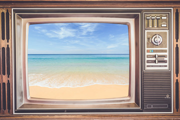 Old TV with tropical sea on screen