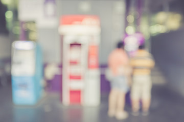 Blurred background : People stand infront of ATM machine