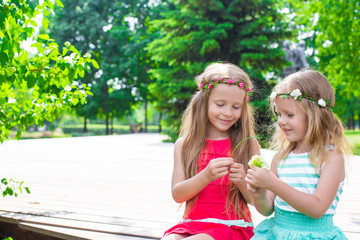 Adorable little girls enjoying warm summer day