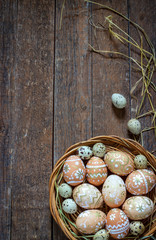 Obraz na płótnie Canvas Easter eggs in the nest on rustic wooden background