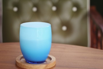Blue glass of water on table