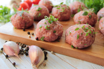 Raw meat balls with herbs prepared for roast
