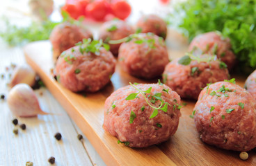 Fresh raw meat balls with herbs