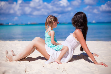 Little girl and happy mother during summer beach vacation