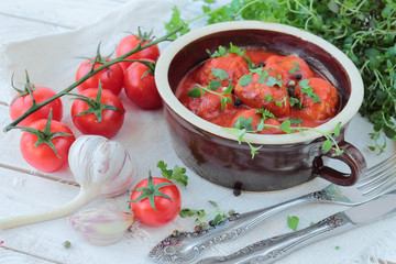 Mealballs in tomatoe sauce with fresh herbs in a bowl