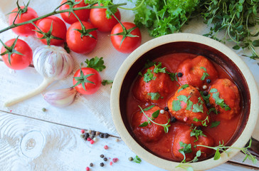 Meatballs in tomatoes sauce with fresh herbs