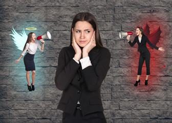 Young businesswoman making choice between good and bad