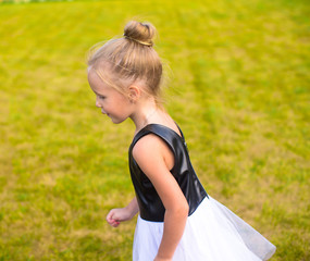 Obraz premium Adorable little girl happy outdoor at summer time