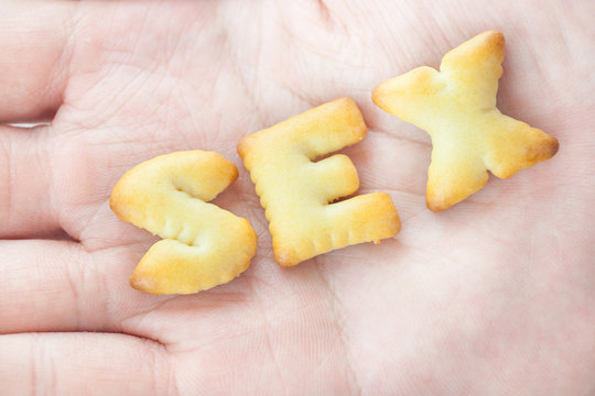 Cookies arranged in Sex Text on Hand