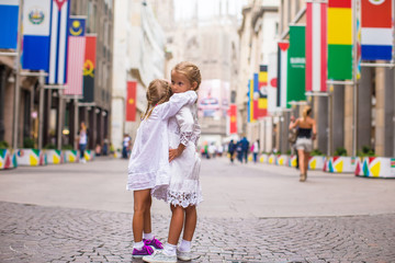 Naklejka premium Little adorable girls walking in Milan on italian vacation
