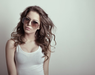 Beautiful teen girl with sun glasses. Fashion girl. Toned.