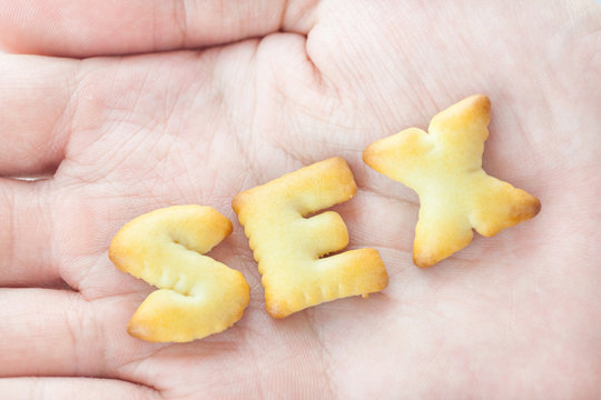 Cookies arranged in Sex Text on Hand